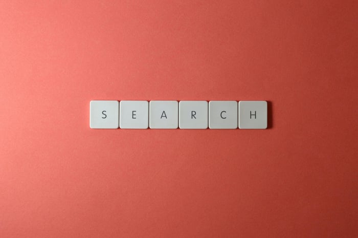 White keyboard keys spelling 'search' on a bold red surface, conceptual design with copyspace.